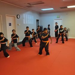 Red Dragon Self Defense - Kids class practicing a block.