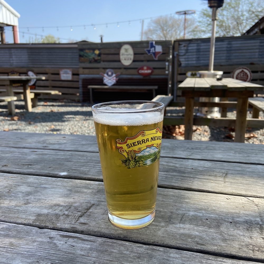 a glass of beer on a picnic table