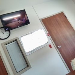 Dignity Health Rehabilitation Hospital - TV, clock schedule board directly in view from bed.