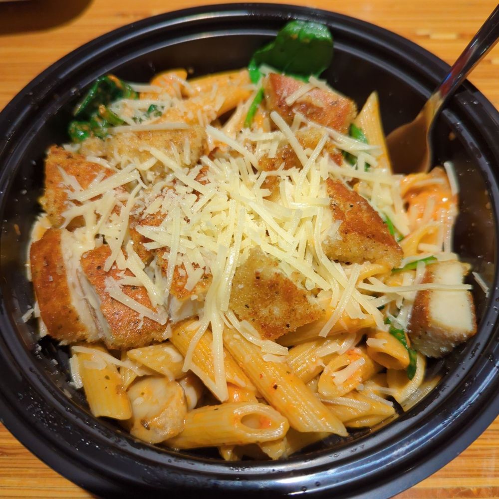 a bowl of pasta with meat and cheese