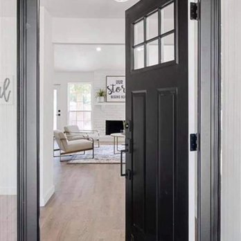 The Pro Crew - a black front door and a white living room - General Contractors Near Me The Pro Crew - a black front door and a white living room - General Contractors Near Me