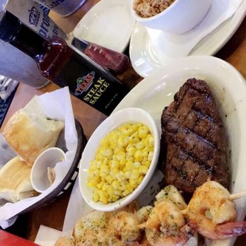 Texas Roadhouse - a 8oz Sirloin Steak 5 pcs of grilled butter and garlic shrimp , buttered corn and seasoned rice and their famous rolls - Steakhouses Near Me - Aurora, Colorado