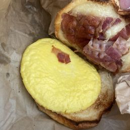 Scrambled egg brioche with cheese (they added bacon) Scrambled egg brioche with cheese (they added bacon)