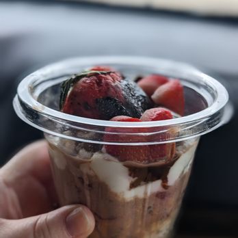Haul'n Oats - a hand holding a container of yogurt - Coffee & Tea Near Me - Muncie, Indiana