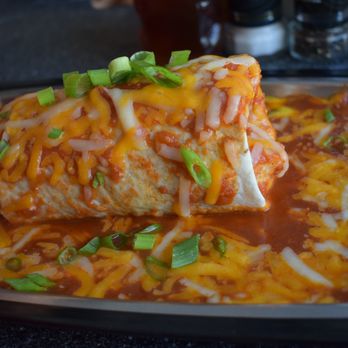 The Blue Hen Cafe - Husband breakfast burrito with the extra red sauce, cheese and scallions on top. He loved it. - Southern Near Me - Saint Augustine, Florida