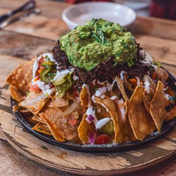 Pablo y Pablo - a plate of nachos with guacamole - Mexican Near Me - Seattle, Washington