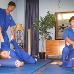 Huang's Health - Pain Treatment Clinic - Wilson, assisting other classmates and students in Thai Massage