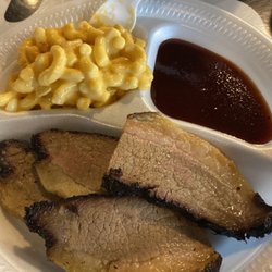 The Watering Hole at Hochatown - Beef brisket sliced, bbq sauce and Mac and cheese.