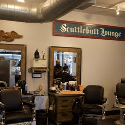 Scuttlebutt Barbershop - The Scuttlebutt Lounge--where classic barber chairs, skilled barbers, and a laid-back vibe make every cut an experience.