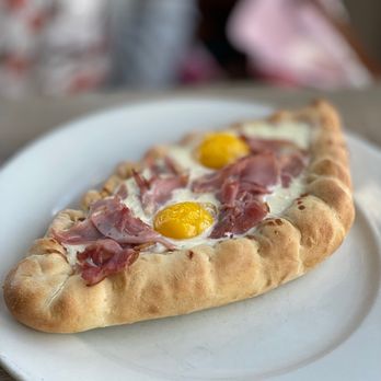 Bramble - 3 Sirens Restaurant Group - Khachapuri--cheese bread, three cheese fondue, two baked egg yolks with ham - Breakfast & Brunch Near Me - Tulsa, Oklahoma