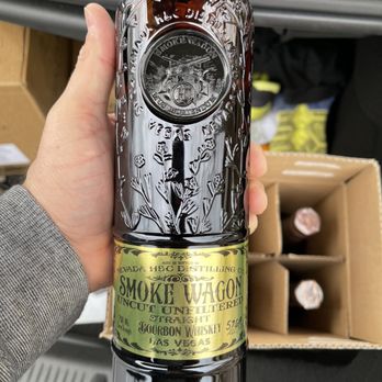 Bourbons & More - a hand holding a bottle of bourbon - Beer, Wine & Spirits Near Me - Roseville, California Bourbons & More - a hand holding a bottle of bourbon - Beer, Wine & Spirits Near Me - Roseville, California