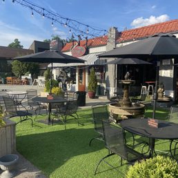 a patio with tables, chairs, and umbrellas a patio with tables, chairs, and umbrellas