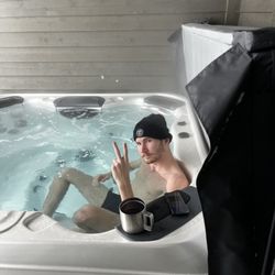 Bullfrog Spas Factory Store - My son relaxing in the spa on One of the worst storm days of last season.