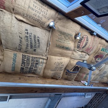 Higher Ground Coffee - a wall of bags of coffee - Coffee & Tea Near Me - Salt Lake City, Utah