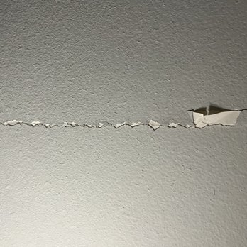 Grapevine TwentyFour 99 - Massive crack, plaster falling off - Apartments Near Me - Grapevine, Texas