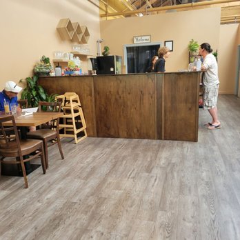Golden Coconut - a woman standing at a counter in a restaurant - Vietnamese Near Me - Fergus, Ontario Golden Coconut - a woman standing at a counter in a restaurant - Vietnamese Near Me - Fergus, Ontario