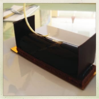 French Corner Cafe - Madagascar pastry, dark chocolate filled with orange mousse - Bakeries Near Me - Palm Desert, California French Corner Cafe - Madagascar pastry, dark chocolate filled with orange mousse - Bakeries Near Me - Palm Desert, California