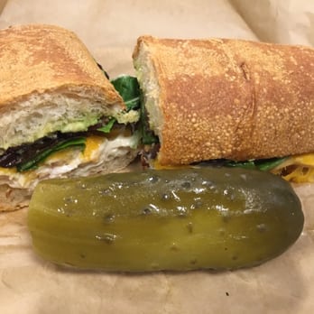 Homegrown - Turkey, Bacon + Avocado and pickle (with a little bite out of it..haha)! - Sandwiches Near Me - Seattle, Washington