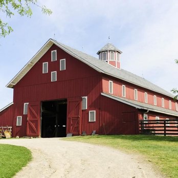 Trusted Texas Home Inspections - A large red wooden barn with multiple entrances, ventilation features, and surrounding green landscape showcases durable agri... - Home Inspectors Near Me - Weatherford, Texas Trusted Texas Home Inspections - A large red wooden barn with multiple entrances, ventilation features, and surrounding green landscape showcases durable agri... - Home Inspectors Near Me - Weatherford, Texas