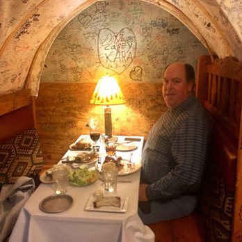 Anton's Restaurant - Hubby in graffiti covered wagon booth-very cozy. - Seafood Near Me - Waite Park, Minnesota