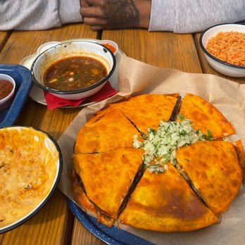 NIDO's BackYard - Queso dip to the left, quesabirria pizza, and rice. - Mexican Near Me - Oakland, California NIDO's BackYard - Queso dip to the left, quesabirria pizza, and rice. - Mexican Near Me - Oakland, California