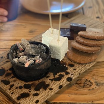 Campfire - S'mores: creamy gooey vanilla mellows with rich dark fudgy chocolate and cinnamon graham cracker to sandwich it all together. - New American Near Me - Carlsbad, California Campfire - S'mores: creamy gooey vanilla mellows with rich dark fudgy chocolate and cinnamon graham cracker to sandwich it all together. - New American Near Me - Carlsbad, California