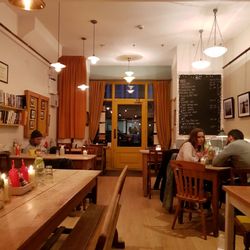 The Step - Odd assortment of tables and chairs, lights and wall decoration but it works
