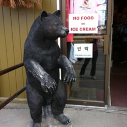 Around the Corner - Big bear outside of entrance of store