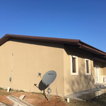 Escalante’s Construccion - a house with a satellite dish - Stucco Services Near Me