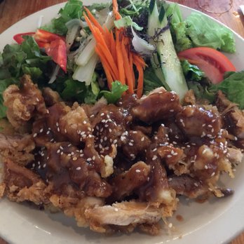 Miyo's Restaurant - Sesame chicken with tossed greens. A bowl of rice is also served on the side. - Izakaya Near Me - Hilo, Hawaii Miyo's Restaurant - Sesame chicken with tossed greens. A bowl of rice is also served on the side. - Izakaya Near Me - Hilo, Hawaii