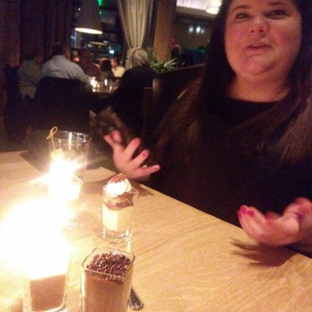 Seasons 52 - My overly photoed friends and our delicious desserts. Mine, and espresso panna cotta. Hers, pecan pie. Both amazing, but mine still better. - New American Near Me - Troy, Michigan
