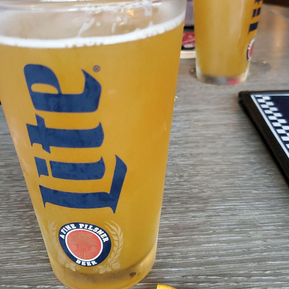 a glass of beer and an orange slice a glass of beer and an orange slice