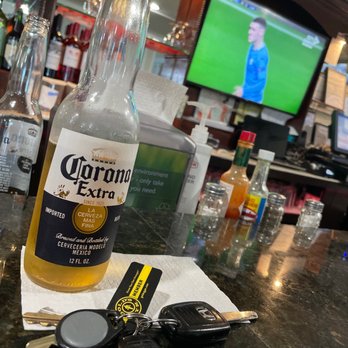 limeño - a bottle of coronaro next to keys on a bar - Sports Bars Near Me - Central Islip, New York limeño - a bottle of coronaro next to keys on a bar - Sports Bars Near Me - Central Islip, New York