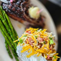 Big Mike's Steakhouse - Big Mike's steak 24oz with loaded bake potatoes and grilled asparagus