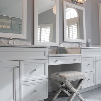 Suran Built - a vanity with a stool and mirrors - General Contractors Near Me - Crystal Lake, Illinois