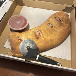 Italian Village Pizza & Beer - Pepperoni calzone... Also sliced up before I took my pic. Family loves the calzones.