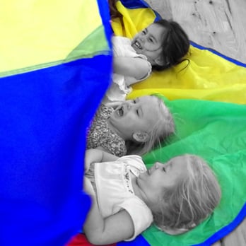 Babies & Beyond Daycare - Playing with one of those colorful parachute things! - Child Care & Day Care Near Me - Grass Valley, California Babies & Beyond Daycare - Playing with one of those colorful parachute things! - Child Care & Day Care Near Me - Grass Valley, California