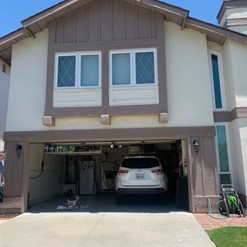 Ace Crown Painting - Before: open garage-trim was weather worn, old paint. - Painters Near Me