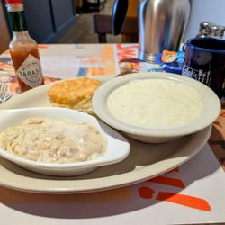 Caleb's - Biscuit, gravy, big bowl of grits, peeking sausage patty.