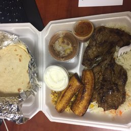 Honduran dinner.  Plantains, tortillas, steak, rice, beans, chorizo and eggs,  and sauces for $13.