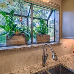 Ctm Remodel & Design Center - The garden window is encased in quartz and the wall is tiled all around it with the backsplash subway tile.