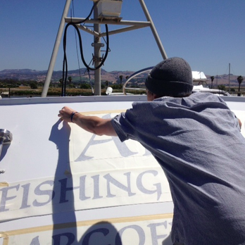 Napa Sign Shop - Cody installing his half of our vinyl sign for the boat front. It was windy. Don't know how they managed! - Signmaking Near Me - Napa, California Napa Sign Shop - Cody installing his half of our vinyl sign for the boat front. It was windy. Don't know how they managed! - Signmaking Near Me - Napa, California