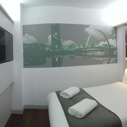 Point A Hotel - Pano of a no-window room on first floor. Toilet to the right of frame and room door behind.