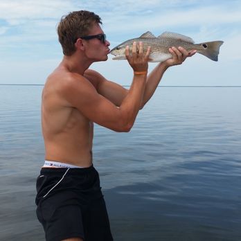 BigWave Boat Rentals - A Customer Kissing His Puppy Drum - Boating Near Me - Kill Devil Hills, North Carolina BigWave Boat Rentals - A Customer Kissing His Puppy Drum - Boating Near Me - Kill Devil Hills, North Carolina