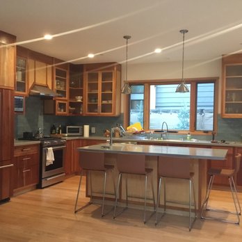 Blue Apple Construction - a kitchen with wood cabinets and stainless steel appliances - General Contractors Near Me - Mountain View, California
