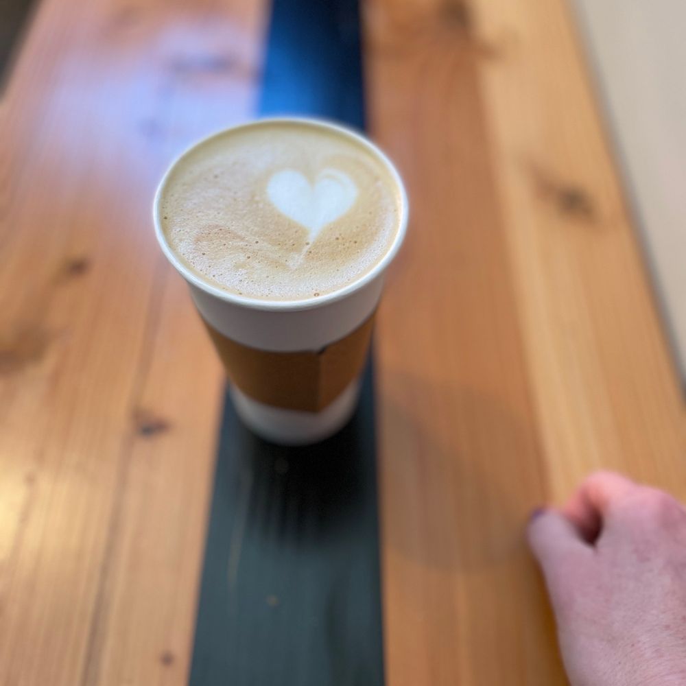 Silk City Coffee - a person holding a cup of coffee - Coffee & Tea Near Me - Manchester, Connecticut