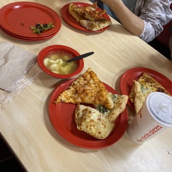 Cicis Pizza - a person eating a slice of pizza - Pizza Near Me - Baton Rouge, Louisiana Cicis Pizza - a person eating a slice of pizza - Pizza Near Me - Baton Rouge, Louisiana
