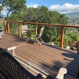 a deck with chairs and a table