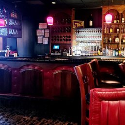 a bar with red leather chairs a bar with red leather chairs