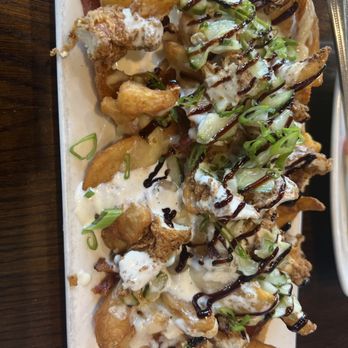 The Woodbury - Woodbury Nachos. Sidewinder fries, fried chicken, bacon, white cheddar cheese, pickiest. Chive ranch and balsamic glaze.  Really good! - New American Near Me - Columbus, Ohio